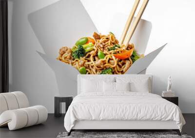 Takeout box with tasty Asian noodle dish, chopsticks, and vegetables. Concept of quick and convenient meal, to go food, fusion cuisine, Asian fusion Wall mural