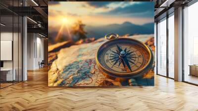 Vintage compass on map with mountain sunset in background Wall mural