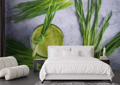 Fresh wheat grass juice and wheatgrass plant for health on top view. Nutrition food. Wall mural