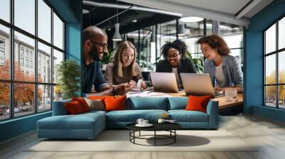 a group of people sitting around a table with laptops, A gathering of individuals seated at a table, each with their own laptop. Wall mural