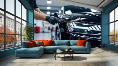 a person in a blue uniform polishing a car, Car detailing experts applying protective coatings for a glossy and durable finish Wall mural