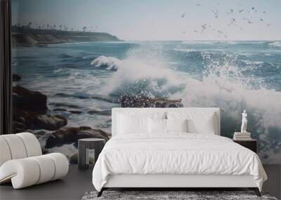 wave crashes on rocky beach with birds flying overhead, Ocean waves wildly crashing against the rocks on the shore Wall mural