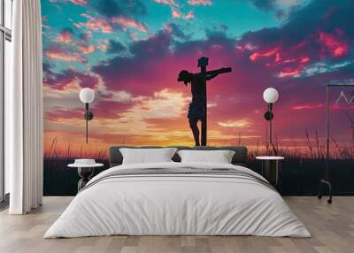 A silhouette of Jesus on the cross at sunset, with the sky ablaze in colors, symbolizing sacrifice and redemption. Wall mural