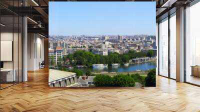 Paris, France - August 26, 2019: Paris from above showcasing the capital city's rooftops, the Eiffel Tower, Paris tree-lined avenues with their haussmannian buildings and Montparnasse tower. 16th Wall mural