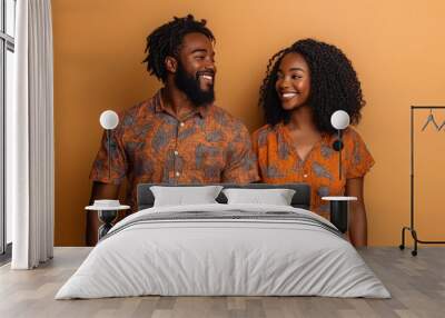 A joyful African American couple stands together, smiling in their matching summer outfits, radiating happiness and warmth Wall mural