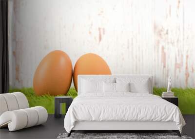 Hen eggs on green grass Wall mural