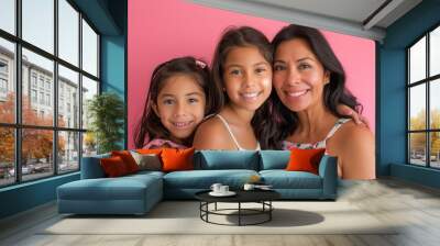 A mother and two daughters are posing for a photo Wall mural