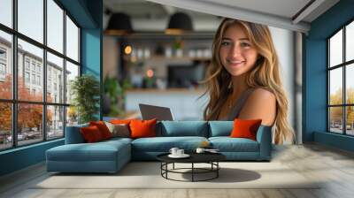 Latina freelancer, woman 25 year old Hispanic holding an open laptop, with a modern office background. Wall mural