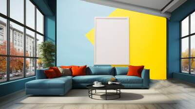 Blank white frame on a yellow-blue background.Mock up Wall mural