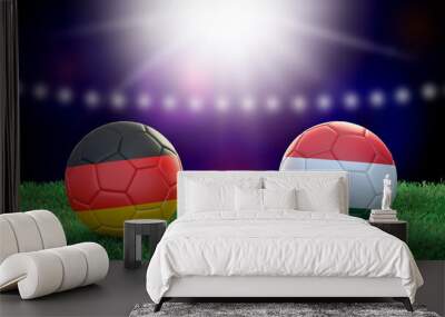 Two soccer balls in flags colors on stadium blurred background. Germany and Hungary. 3d image Wall mural