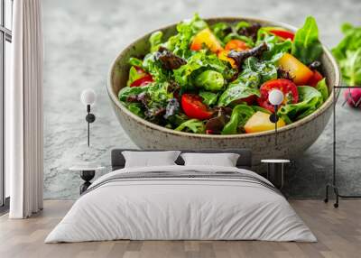 Fresh salad with tomatoes and leafy greens in a bowl. Wall mural