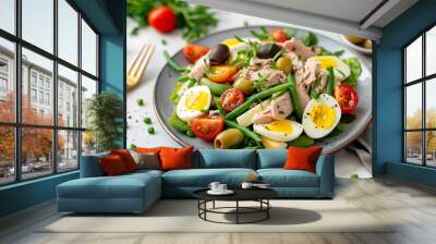 French salad Nicoise with tuna, eggs, green beans, tomatoes, olives, lettuce and anchovies. Wall mural