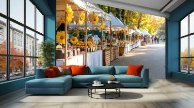 A row of tents with yellow flowers hanging from them. There are many people walking around and shopping Wall mural