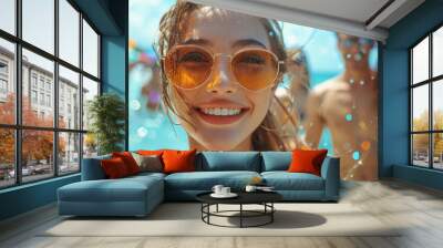 A joyful group enjoying a sunny day at the beach with clear water and vibrant umbrellas in the background Wall mural