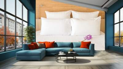 a white bed with 4 pillows and 2 head lights Wall mural