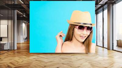 Young Asian woman with happy smile isolated on blue background. Wall mural