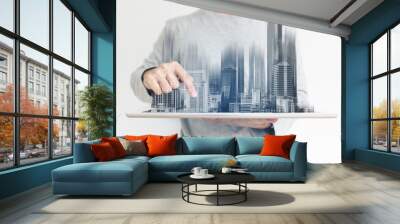 a man using digital tablet, and modern buildings hologram. Real estate business and building technology concept Wall mural