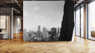 Businessman extending hand with panoramic cityscape of business district in the city Wall mural