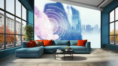 Businessman stretch out hand, with buildings hologram and futuristic interface technology Wall mural