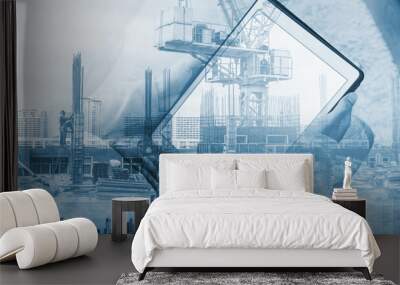 double exposure, a man using digital tablet and buildings construction with cityscape Wall mural