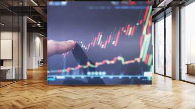 Finger pointing on stock exchange market chart, raising graph. Business and investment growth Wall mural