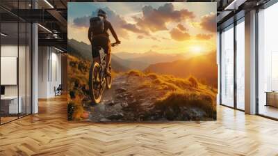 A cyclist on a mountain trail at golden hour, the setting sun casting a warm glow over the landscape, illustrating the thrill of exploring nature on two wheels. Wall mural