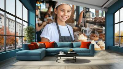 A teenage girl selling baked goods at a bake sale, smiling as she hands a cupcake to a customer, learning entrepreneurial skills through her venture Wall mural