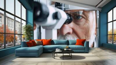 Elderly man undergoing an eye examination at an optometrist's office Wall mural