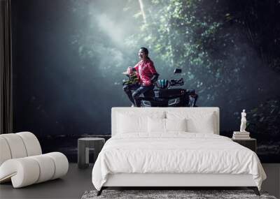 Elegant woman riding quadricycles ATV in forest Wall mural