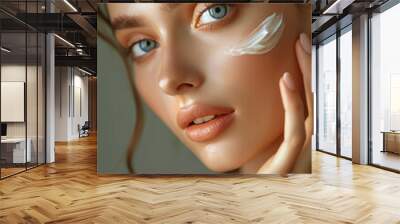 Hydration. Cream smear. Beauty close up portrait of young woman with a healthy glowing skin is applying a skincare product. Wall mural