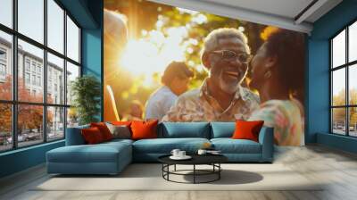 Individuals of all ages laughing and dancing at a family reunion, with warm sunlight filtering through the trees. Wall mural