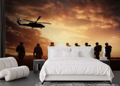 Military silhouettes of soldiers and airforce against the backdrop of sunset sky. Wall mural