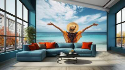 Summer vacation happy carefree joyful bikini woman arms outstretched in happiness enjoying tropical beach destination. Holiday girl sitting with sun hat relaxing from behind on Caribbean vacation. Wall mural