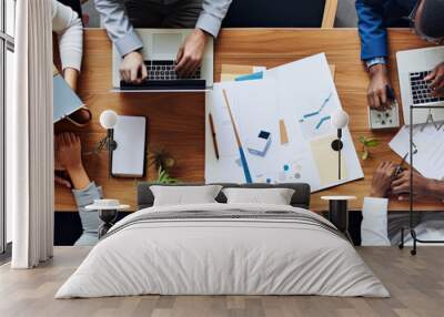 Top view of group of multiethnic busy people working in an office, Aerial view with businessman and businesswoman sitting around a conference table with blank copy space, Business meeting concept Wall mural