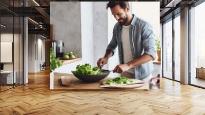 Young man cooking lunch at home. Handsome man preparing delicious food. Wall mural