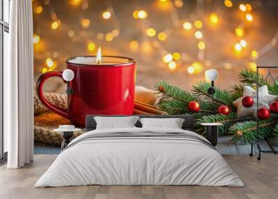 Cozy Christmas atmosphere with red festive mug, lit candle, decorations, bokeh lights Wall mural