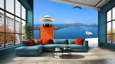 Banner of travel concept with Orange luggage and hat as landscape view of Oia town in Santorini island in Greece , Greek landscape as blue sky background Wall mural