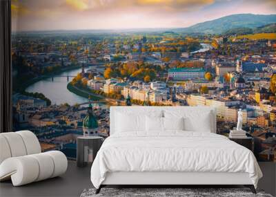 Beautiful of Aerial panoramic view in a Autumn season at a historic city of Salzburg with Salzach river in beautiful golden evening light sky and colorful of autumn at sunset, Salzburger Land, Austria Wall mural