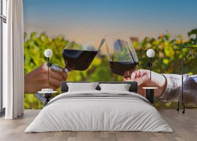 Close up of couple  drinking wine as having fun in the wineyards with evening sky scene at  Bordeaux France Wall mural