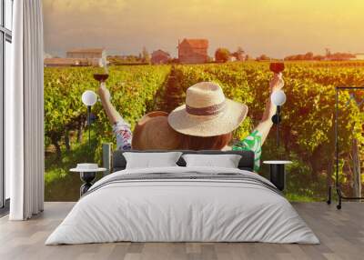 Happy time with back view of young women friends drinking red wine,which happy moment in vineyard in summer Wall mural