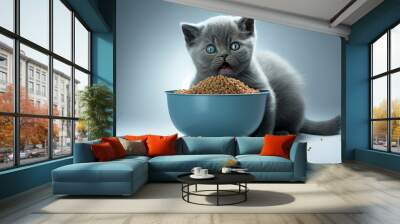 Cute blue British Shorthair cat kitten sitting behind aluminium food bowl filled with dry food kibbles. Looking straight to camera, mouth open and licking mouth.  Isolated cutout on. Generative AI Wall mural