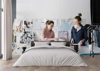 Two sisters artists working on acrylic painting in studio Wall mural