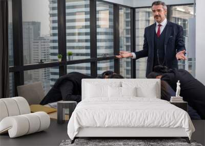 Boss bored and looking down at lazy colleague sleeping on table in meeting room Wall mural