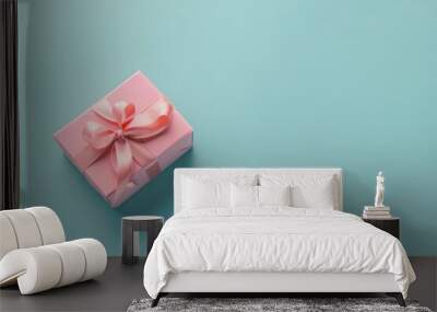 The pink gift package is against a light blue background. Wall mural