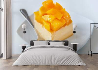 Slice of delicious Mango cheesecake on white plate. Wall mural