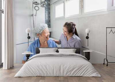 Asian daughter or female care assistant service,help,support senior woman taking a shower in bathroom,take care closely,happy mother is difficult to help herself, the safety and accidents of elderly  Wall mural