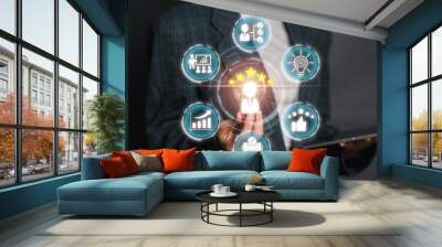 A business professional presenting a skills concept with icons symbolizing different competencies, achievements, and growth areas. Wall mural