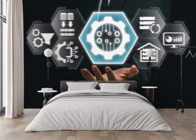 A businessman holding a digital gear icon symbolizing the ETL process in data management, surrounded by related technology icons. Wall mural