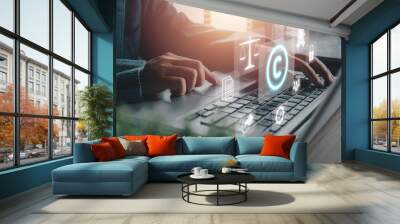 Copyright or patent concept, Person hand using laptop computer on desk with VR screen copyright icon background, Copyleft trademark license, Creation ownership against piracy crime. Wall mural