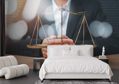 Male lawyer in the office with brass scale on wooden table, justice and law concept. Wall mural